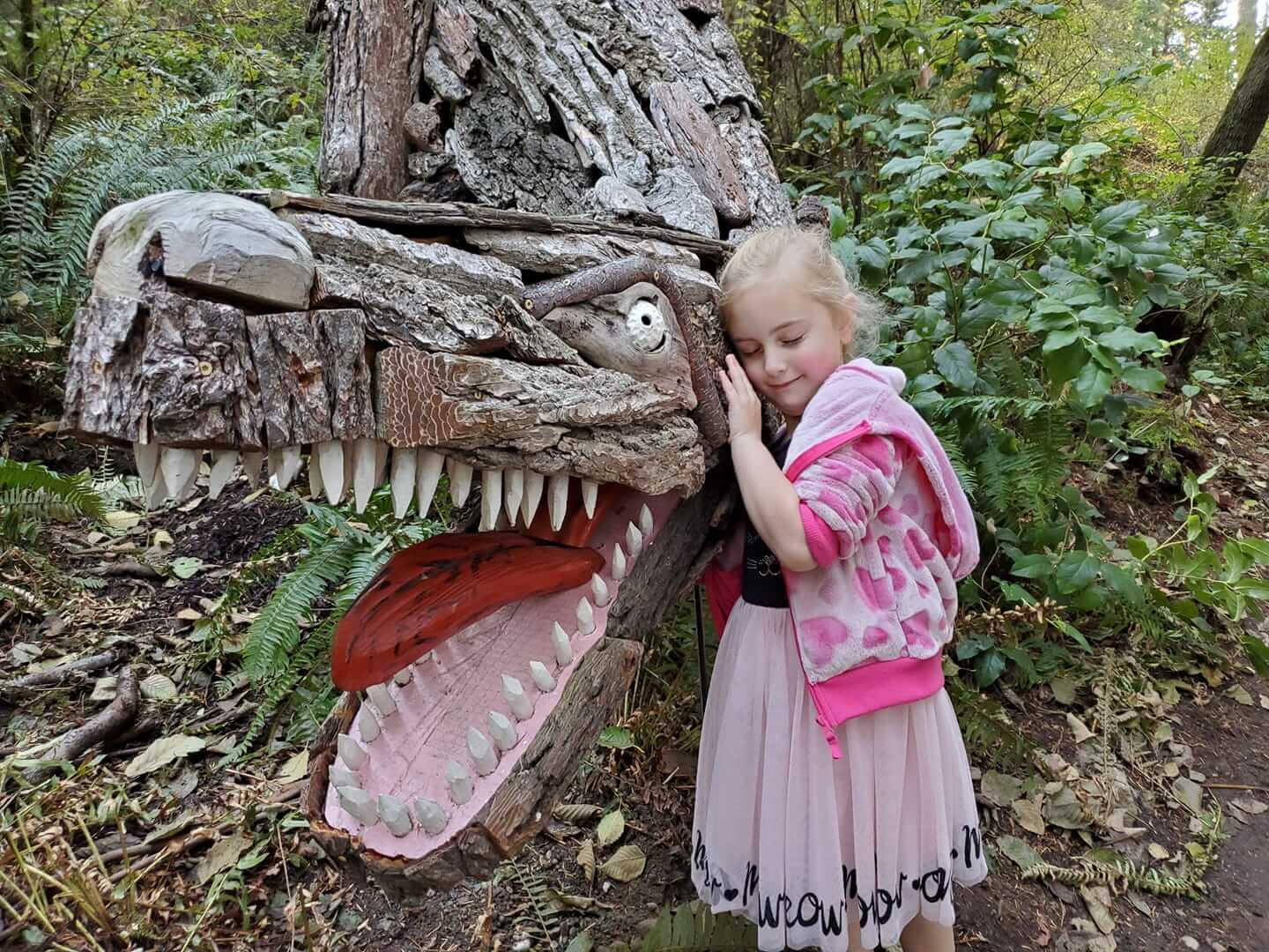 Eva with Tyrannosaurus Rex by Joe Treat at Price Sculpture Forest - photo by Dondi Budde of Oak Harbor-1