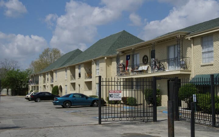 gated apartment complex and parking lot