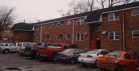 parking lot of brick apartment building