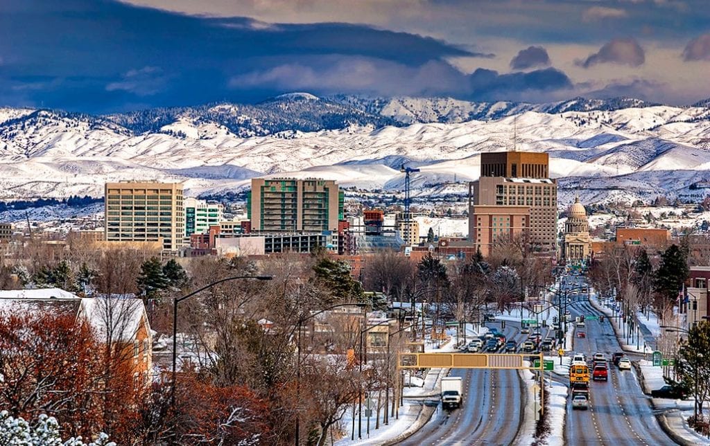 Snowy mountains behind Boise City cityscape